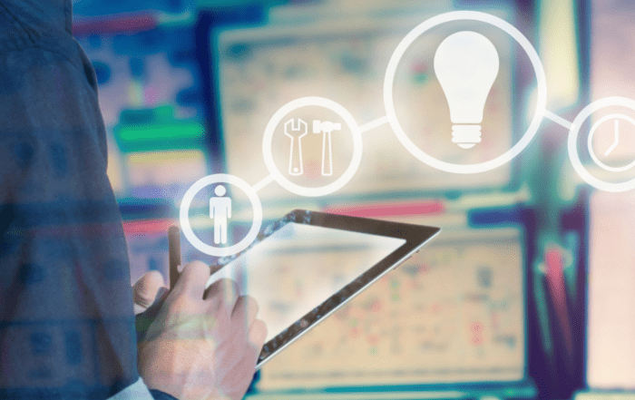 Engineer using a tablet in a control room with digital icons for innovation and maintenance